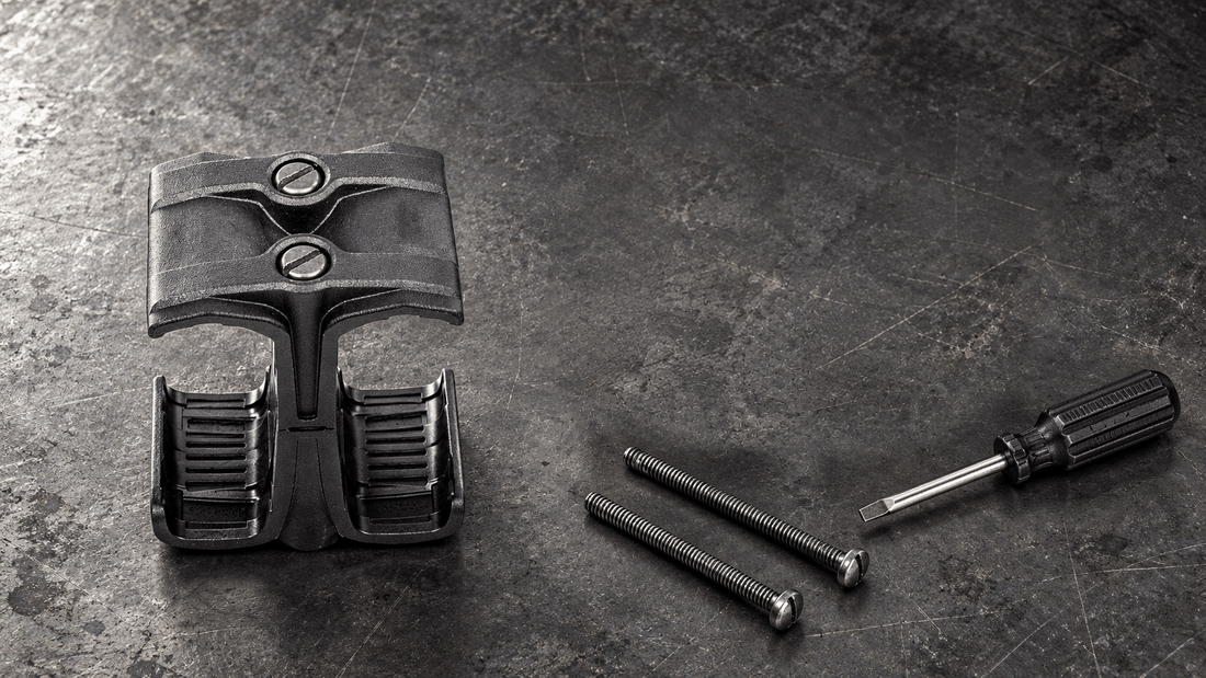 TACFENDER Coupler Mag Holder for PMAG magazines, assembled, with its two screws and a screwdriver on a workbench