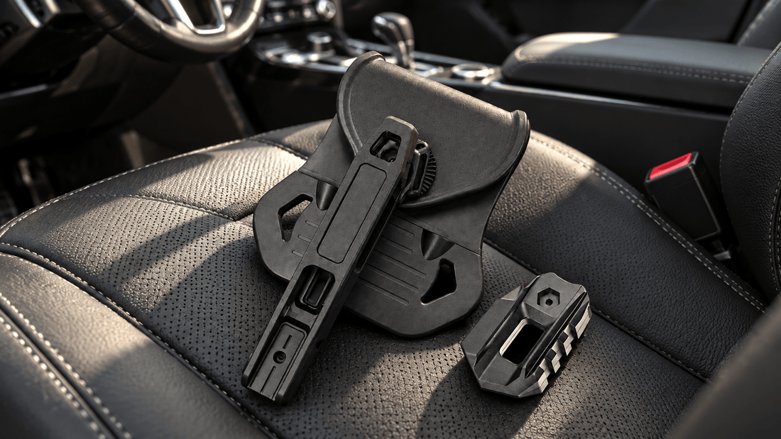 TACFENDER Universal Holster PRO and rail-lock adapter lying on a car seat next to the seatbelt buckle